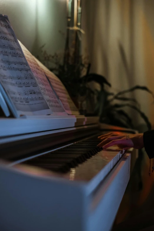 a person with red gloves on playing a piano