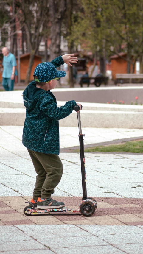 a  riding on a scooter in the street