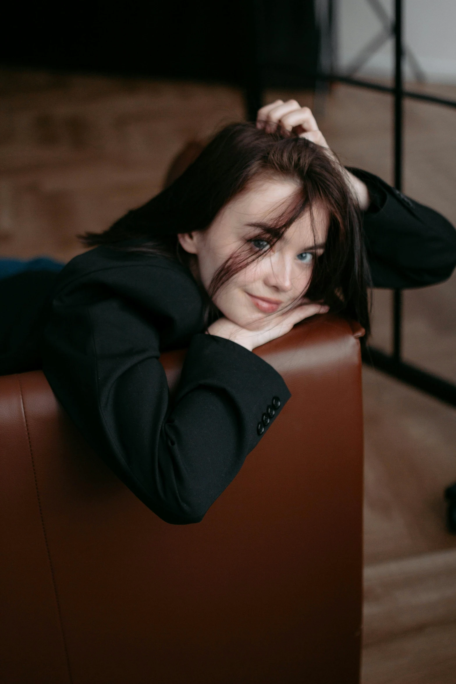 a woman is sitting in the corner with her hands on her head