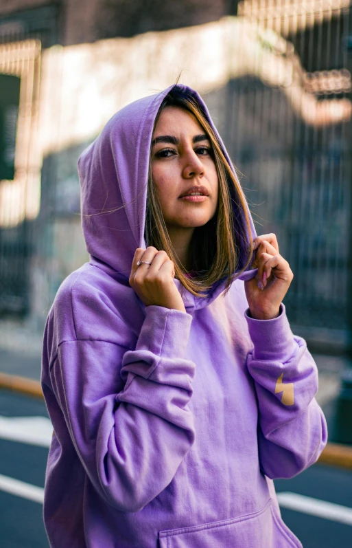 girl in hoodie standing on the street