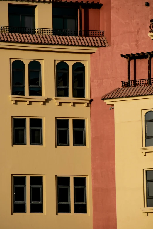 multiple windows on different color and shape buildings