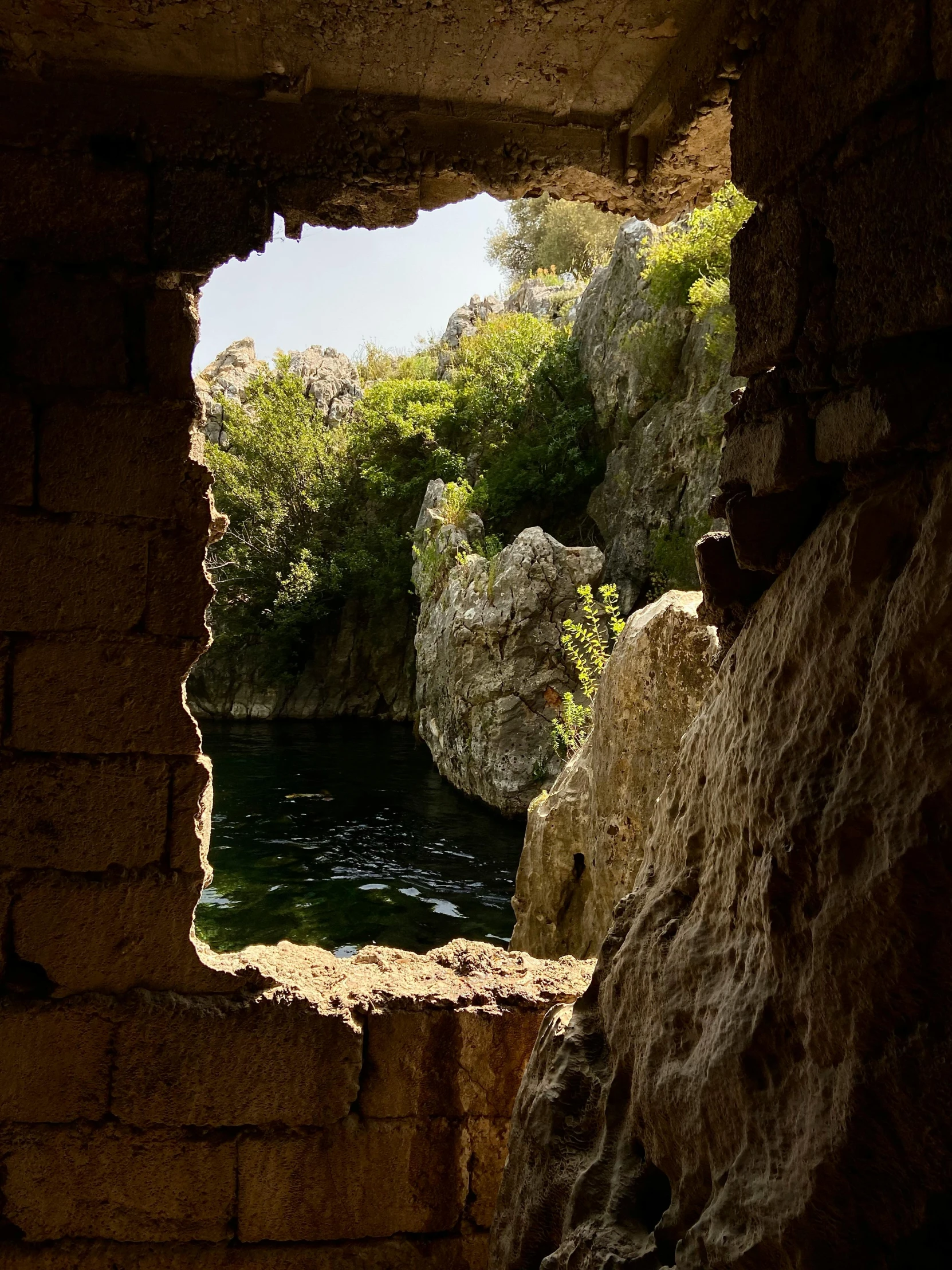 the light comes through an opening in the stone wall