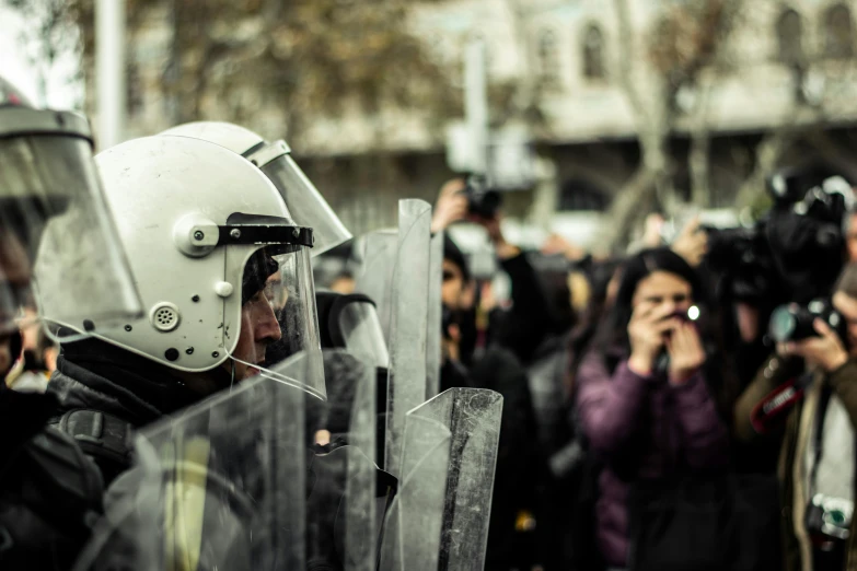 a crowd of people in the street with cameraman