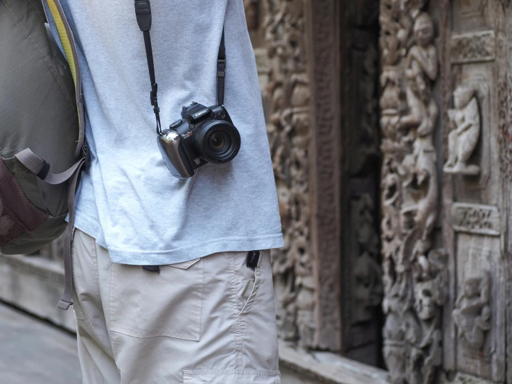 a man standing on the side of a road with a camera