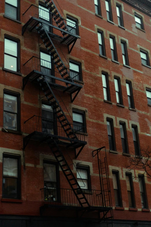 a fire escape in the middle of a large brick building