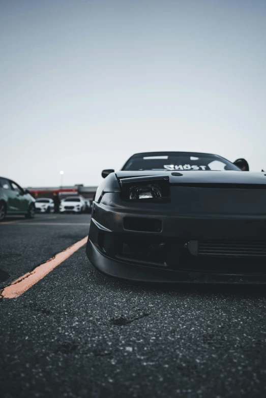 a black sports car parked in the parking lot