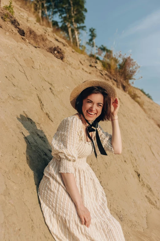 there is a woman sitting on the sand