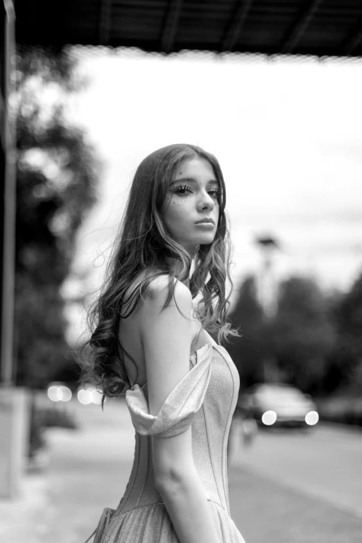 woman in a dress walking down a sidewalk