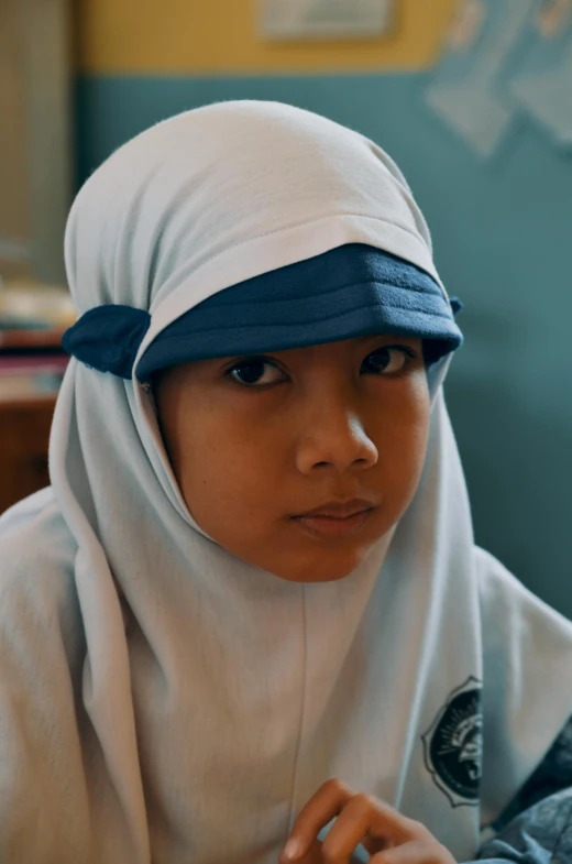 a young woman wearing a white outfit with blue head band