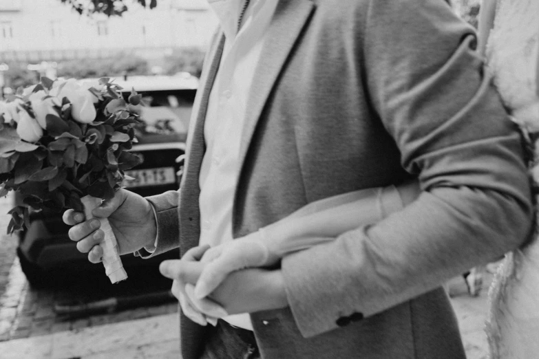 a man is holding a bouquet of flowers