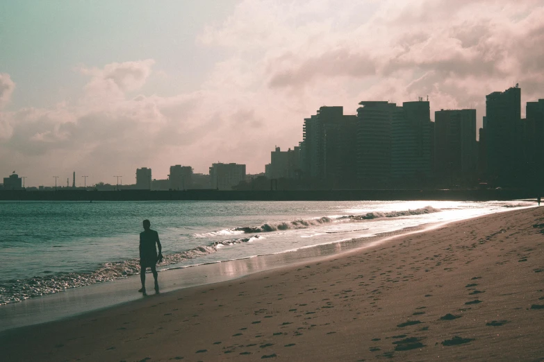 a person is standing in the water near the ocean