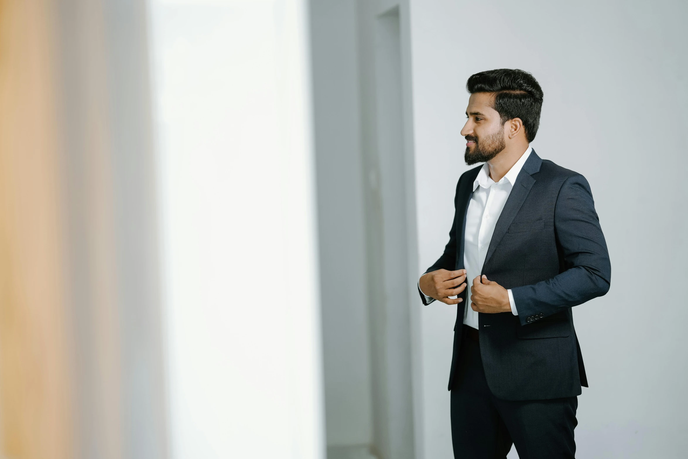 a man standing up looking at his reflection