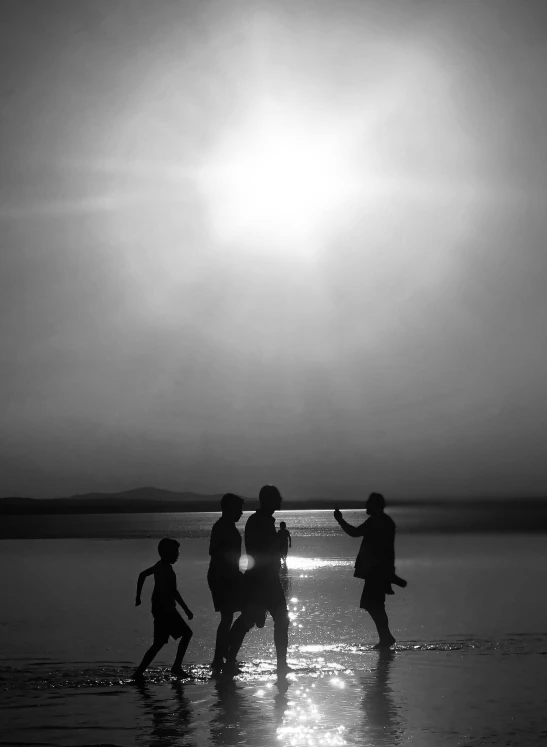 black and white po of children playing at the beach
