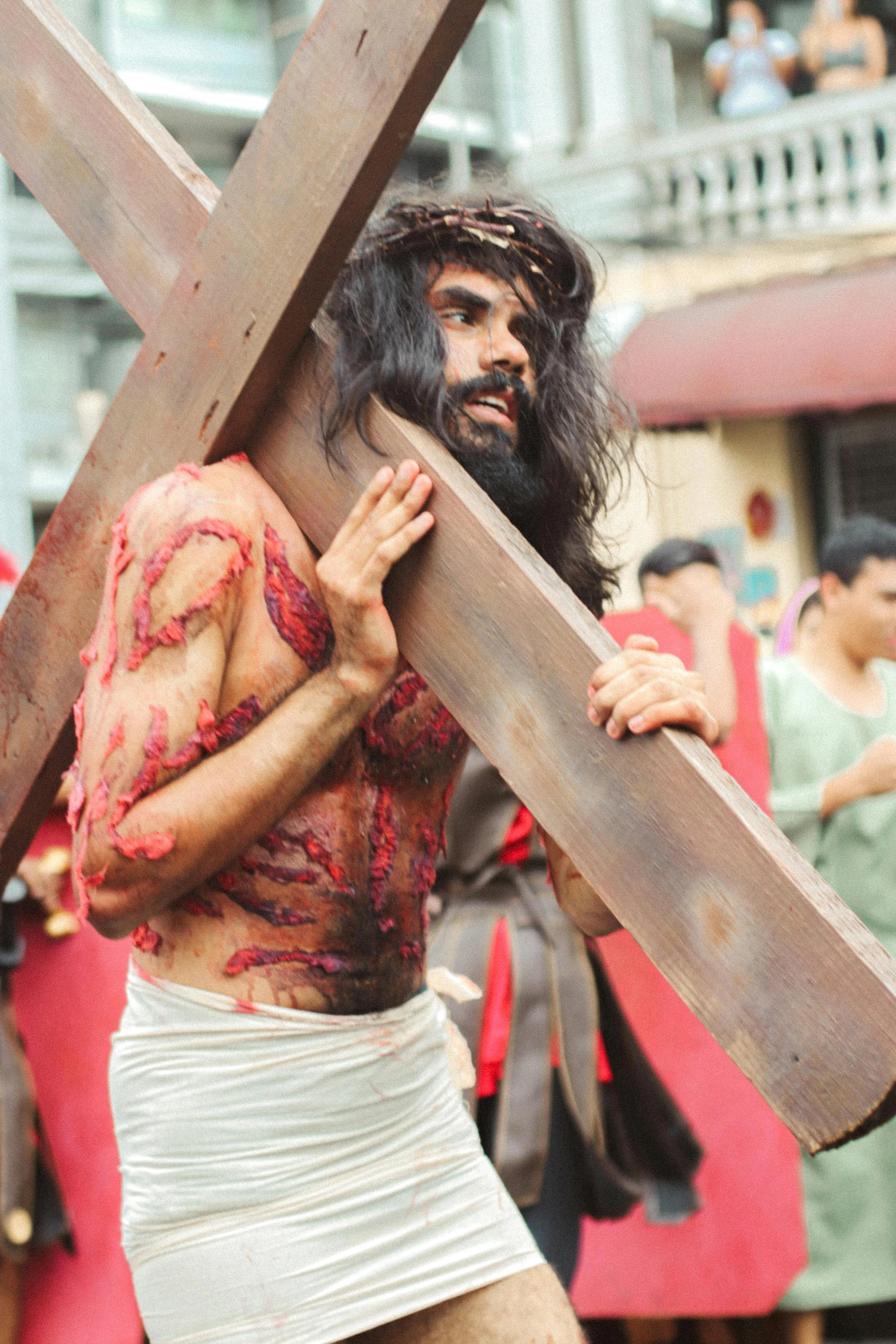 a man in costume carrying the cross in costume