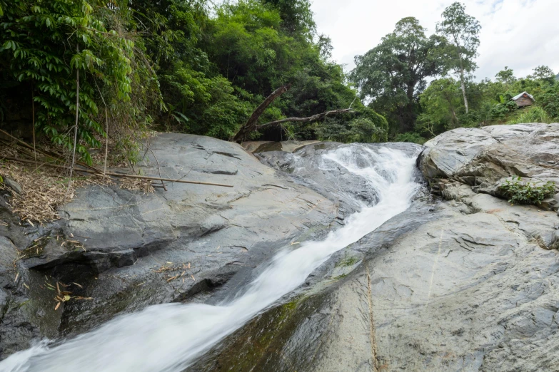 the waterfalls are flowing down the rocky hill