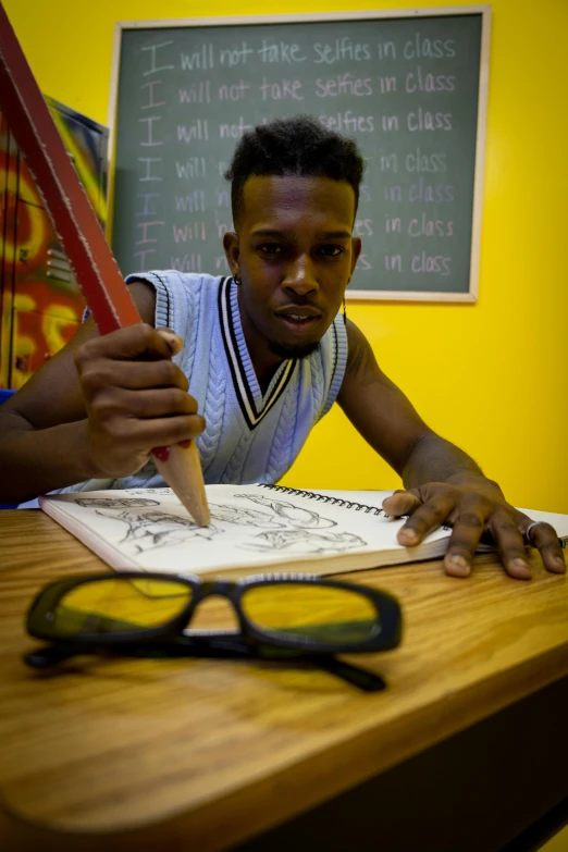 man working on coloring with scissors and pencil