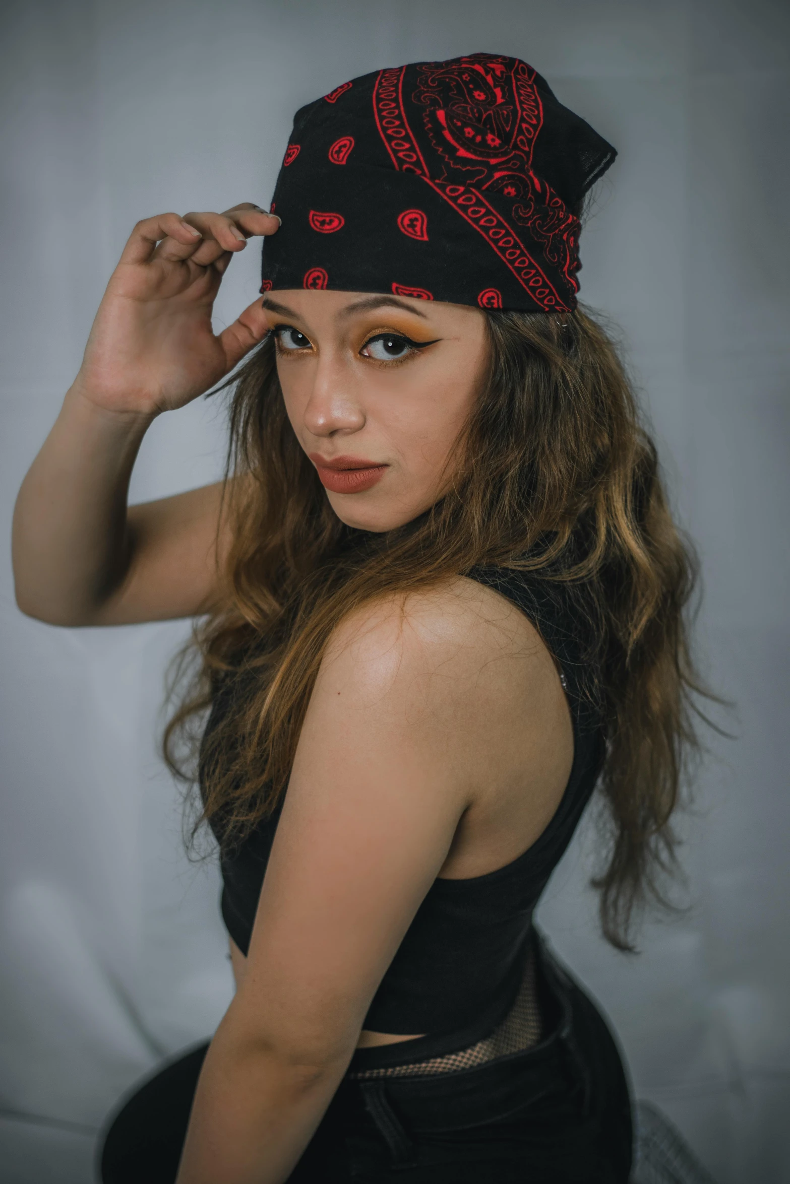 a girl with long hair wears a bandana hat