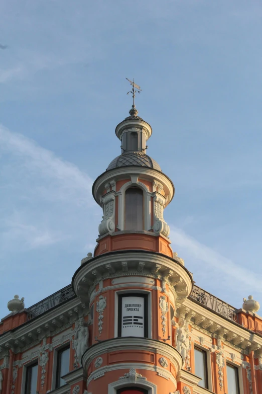 the top of a tall building with a steeple and clock on it