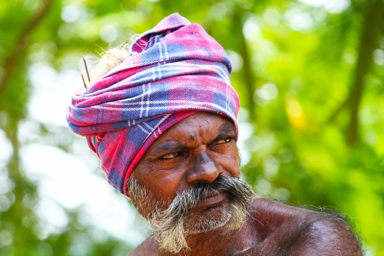 a man with  and a red turban