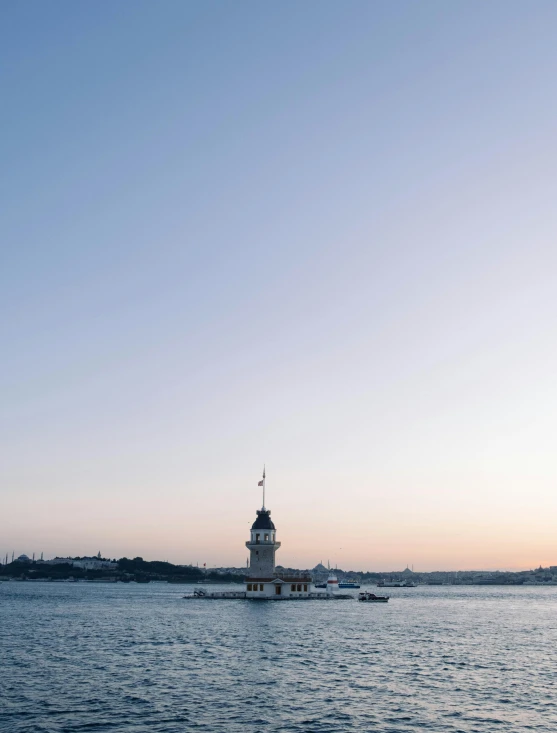 lighthouse sits near calm bay during twilight