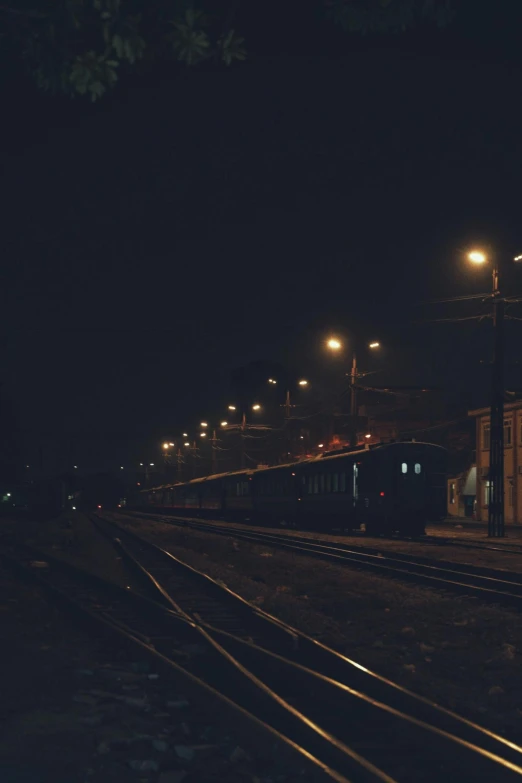 a train is passing through the station at night