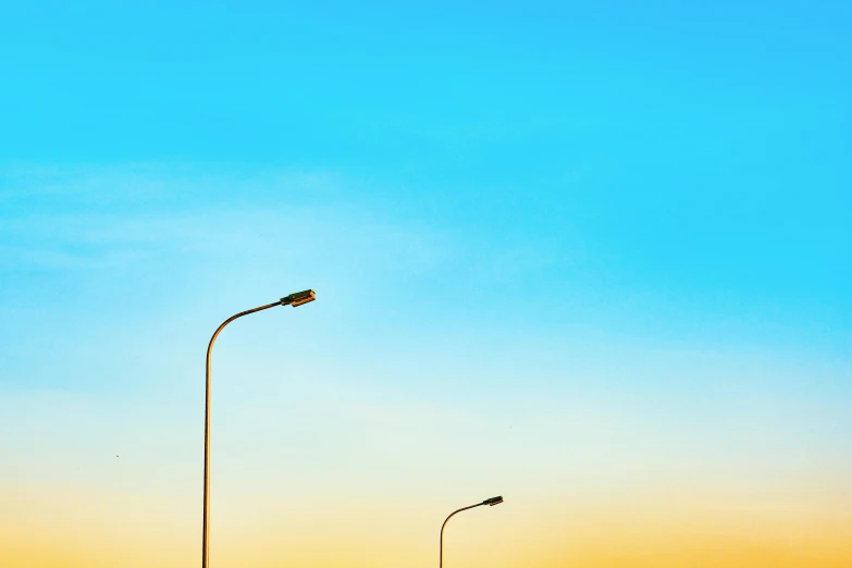 two lamps and street lights on a sunny day