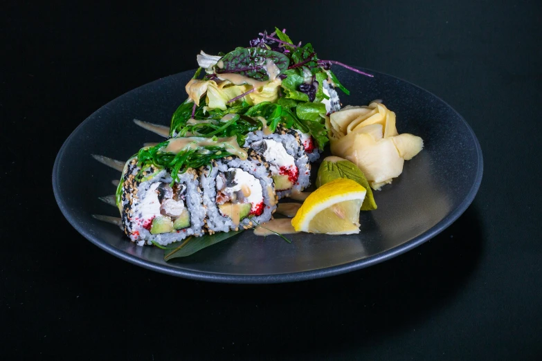 the large meal of vegetables is on a black plate