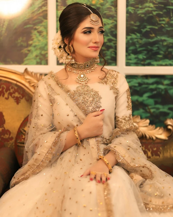 a bride in traditional indian clothing posing for the camera