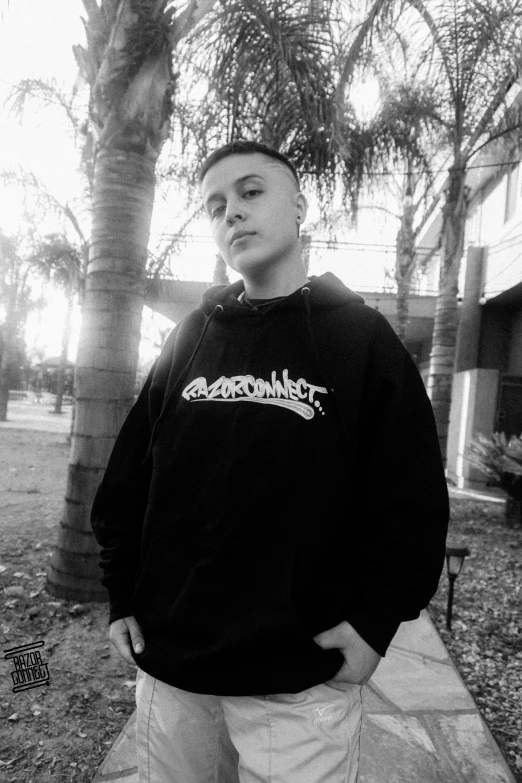 black and white pograph of a man wearing a sweatshirt