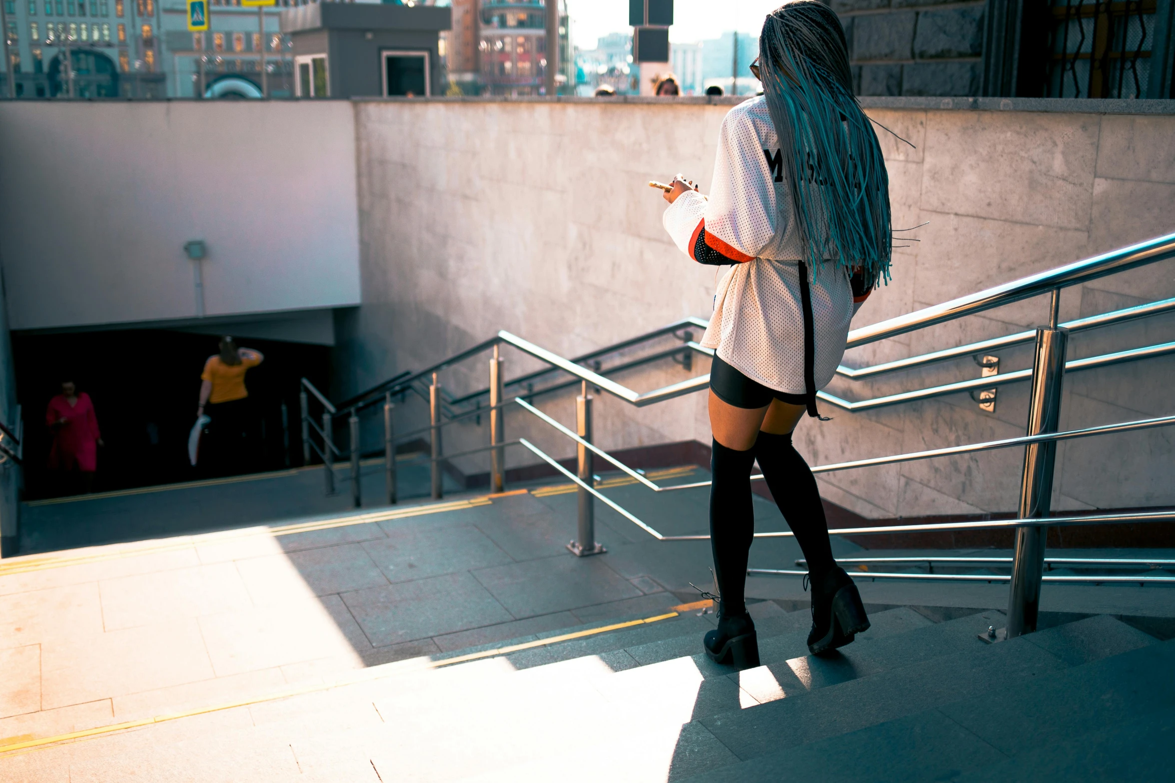 a woman in thigh high boots walking down the steps