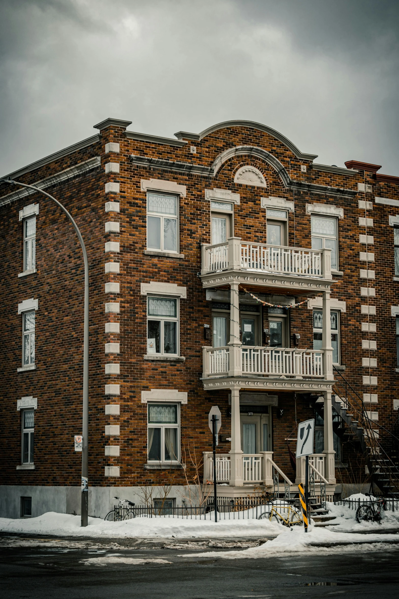 a brown brick building with balconies and windows