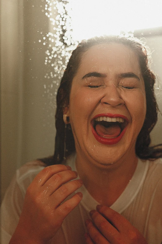 a woman laughing while making faces in front of a mirror