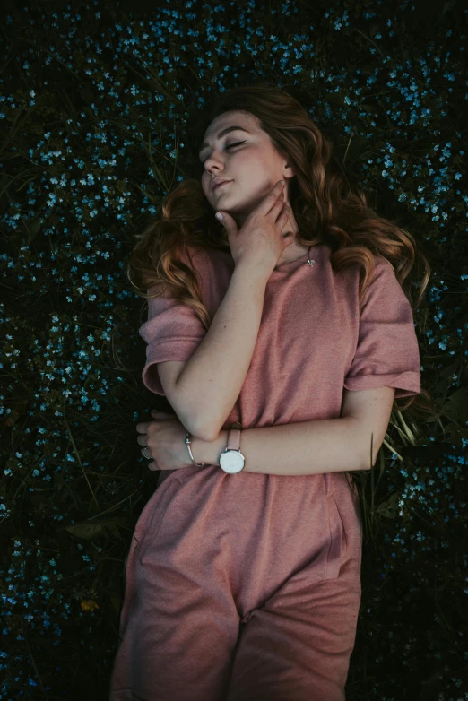 a girl wearing pink in front of a bush