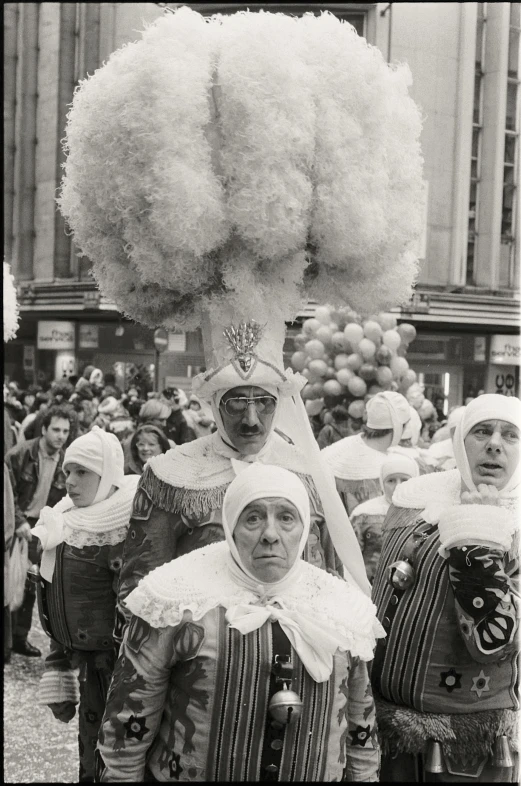 a group of people dressed in costumes and head dresses standing together