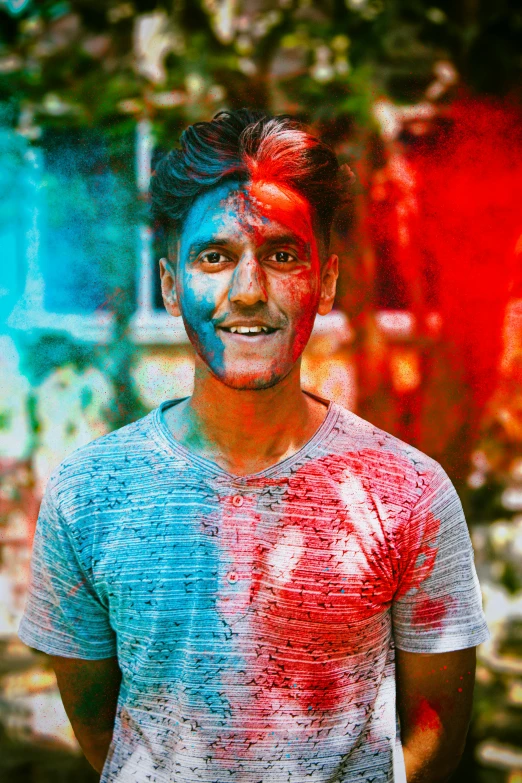 a smiling guy with red and blue paint all over his face