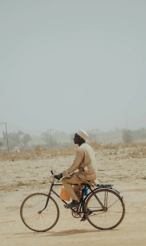 man on bike in a barren area during the day