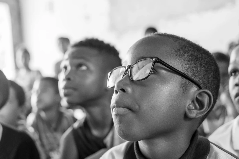 black and white po of young people sitting with their faces tilted