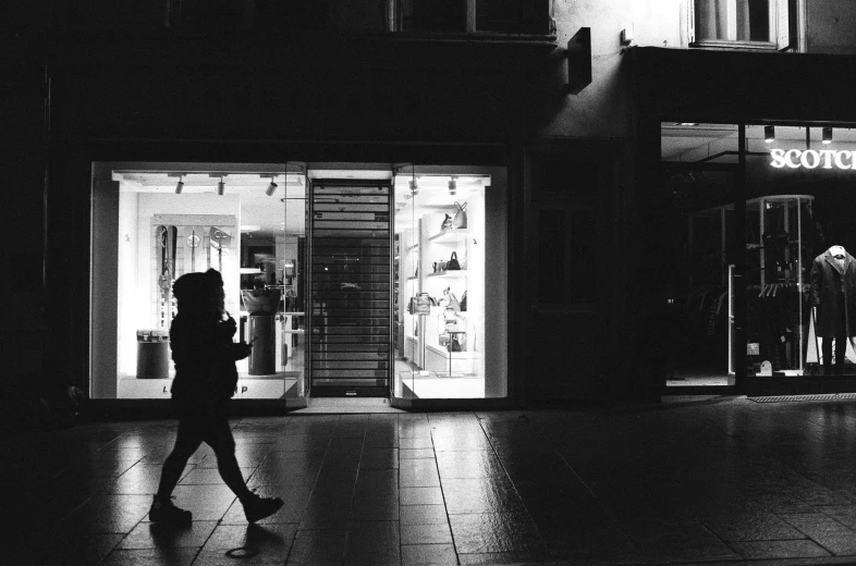 black and white pograph of a woman walking down the street