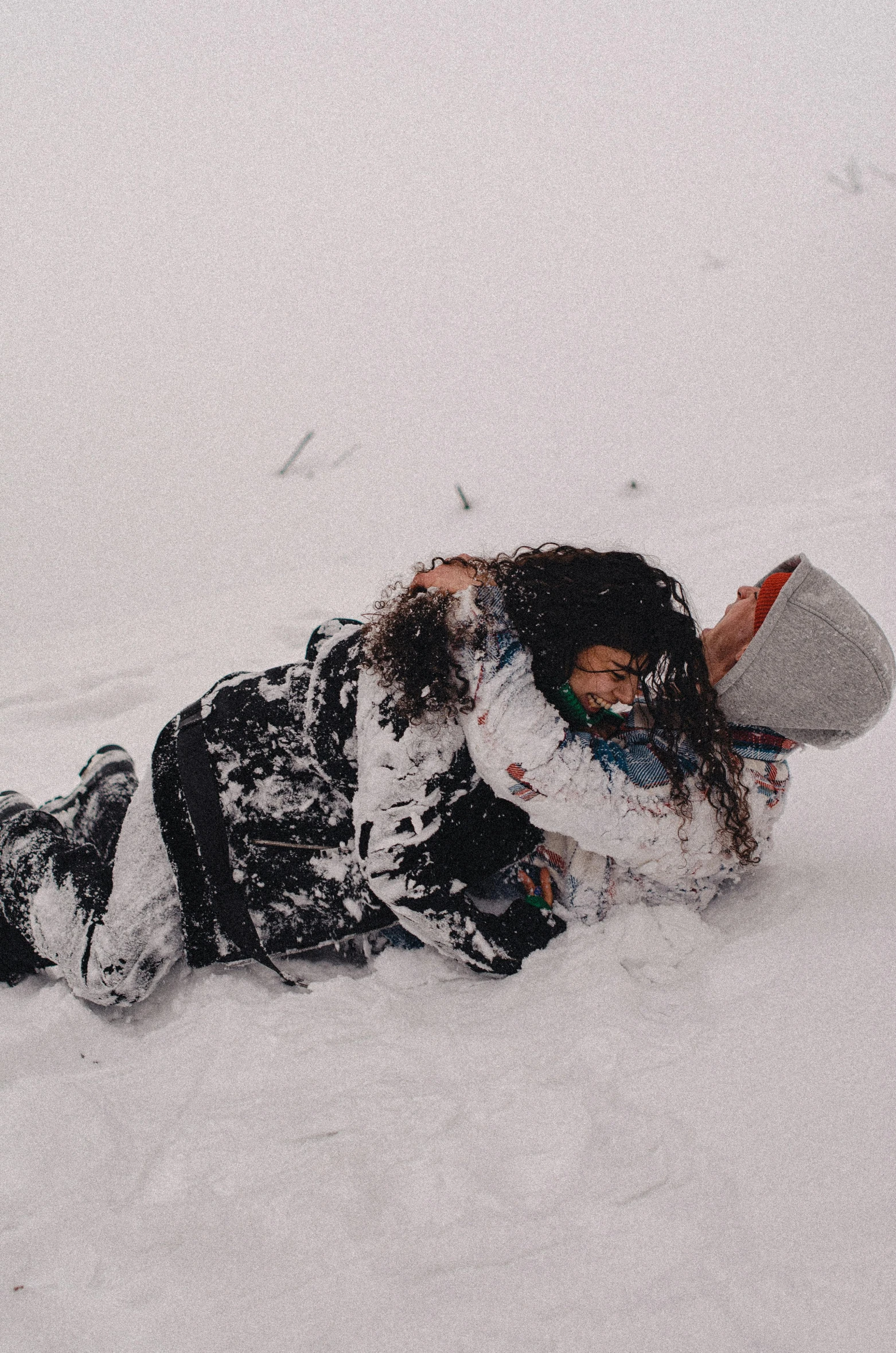 a woman snow boarding down a slope on the snow