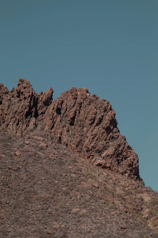 the top of a very big rock formation in the mountains