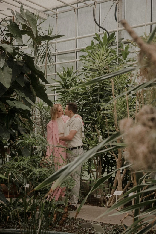 an older couple emce in the midst of green houses