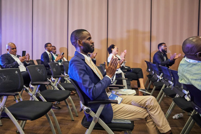 group of black men in office meeting with their hands crossed