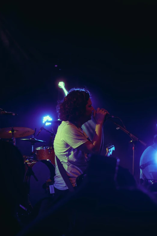 a man that is holding a microphone on stage