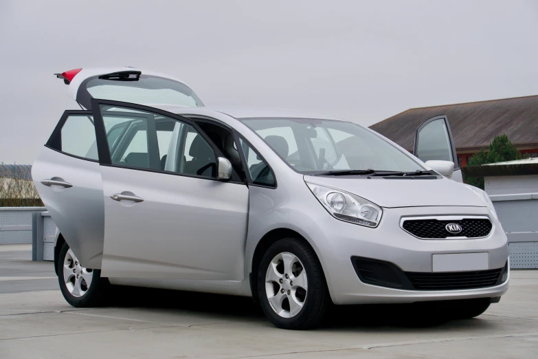 a small car with its door open in a parking space