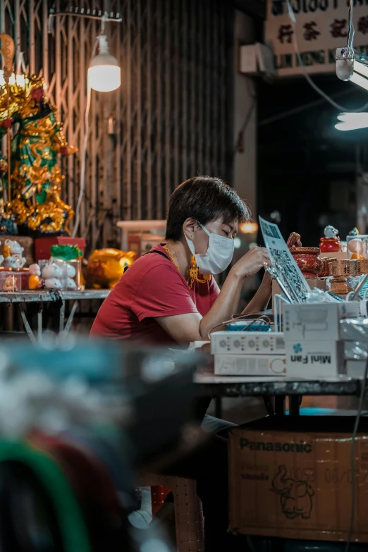 a woman in a store working on her laptop