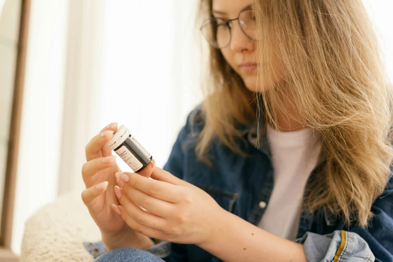 a woman sitting down looking at her cell phone