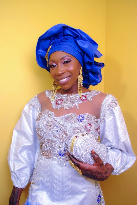 a woman in blue and gold clothing holding a ball