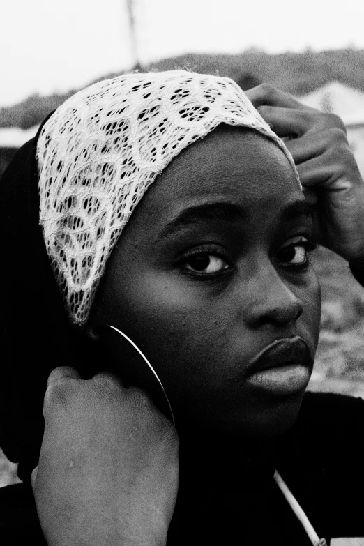 a woman holding a cigarette and looking at the camera