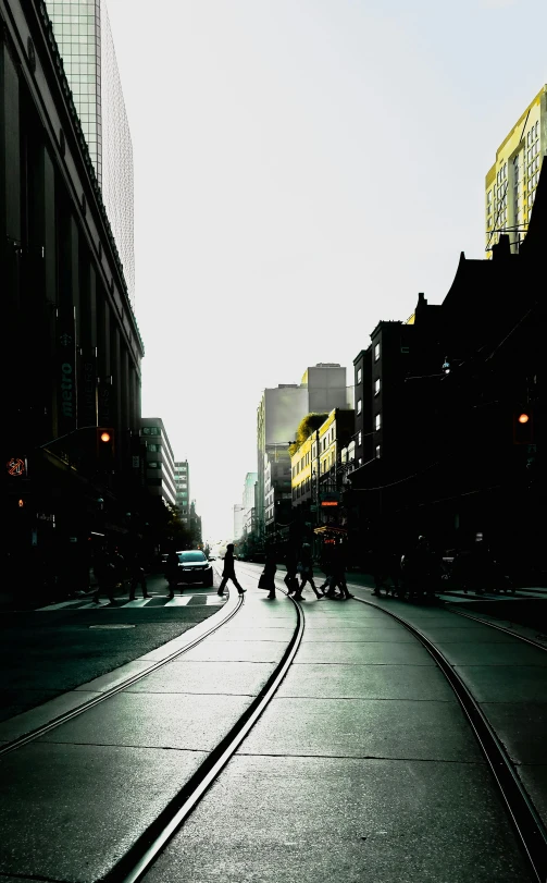 the shadow of a train tracks in a city street