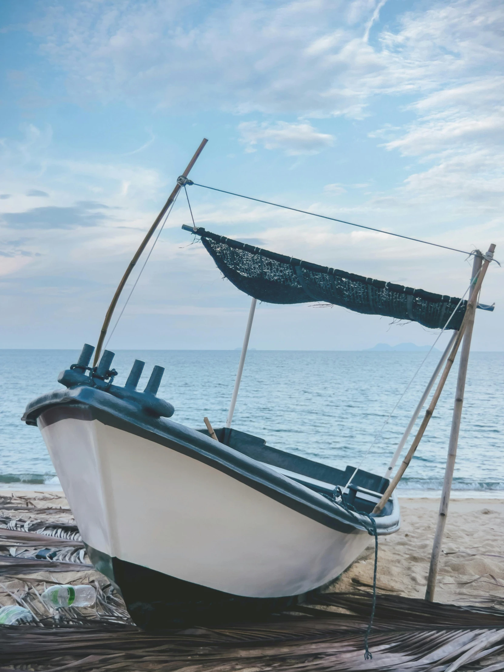 a boat sits on the beach with a rope